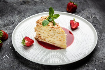 Classic Russian cake Napoleon with creamy vanilla swith cream, apples and strawberry jam decorated mint. banner, menu, recipe place for text, top view