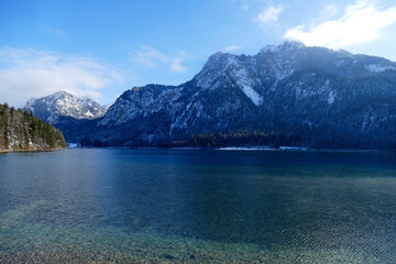Obraz premium Mountain panorama at lake Alpsee in wintertime, Bavaria, Germany