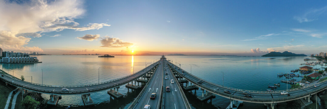 Cars driving across Penang bridge at sunrise, Penang, Malaysia