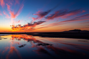 Cloud reflections in sea at sunset, Los Lances beach, Tarifa, Cadiz Province, Andalusia, Spain
