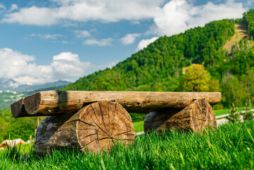 A wooden bench in close-up against the background of a mountain landscape. Mountain landscape of...