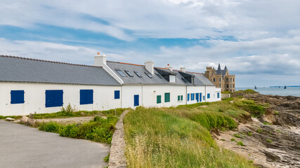 The Turpault castle at Quiberon peninsula, with traditional houses on the coast
