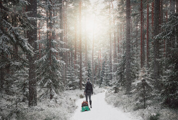 Mother and child are walking in the winter nature.