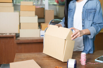 Online business owner preparing product to customer.