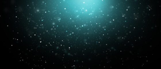 Christmas background. Snow particles on a dark background with a turquoise glow.