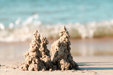 Photo of sand castle on the beach background