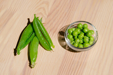 Green pea in glass bowl of top view on rustic wooden background with copy space