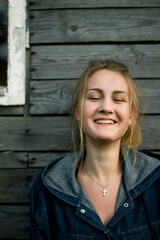 Portrait of a young laughing fair-haired white girl of European appearance at sunset on the...