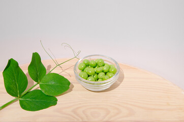Green pea in glass bowl of top view on rustic wooden background with copy space