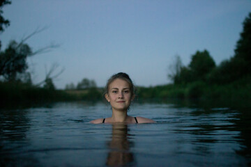 young girl swim evening at the river