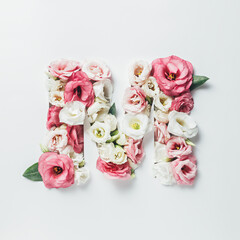 Letter M made with flower and leaves on bright white background. Floral mother's day alphabet...