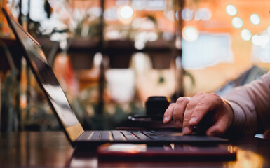 Young man using laptop in cafe, make photo and video, hipster portrait, bears style, freelancer
