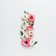 Letter I made with flower and leaves on bright white background. Floral mother's day alphabet concept. Spring blossom, valentine or romantic font collection. Flat lay, top view.