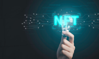 NFT non fungible tokens concept. Hand holding light bulb idea creativity with digital unique art NFT hologram on circuit board