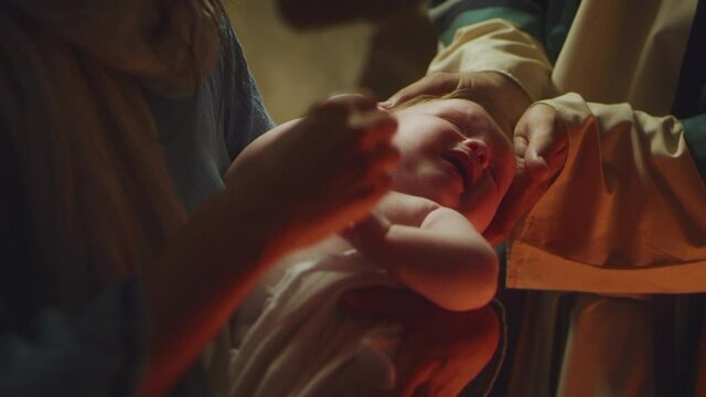 Mary and Joseph comforting crying baby Jesus nativity