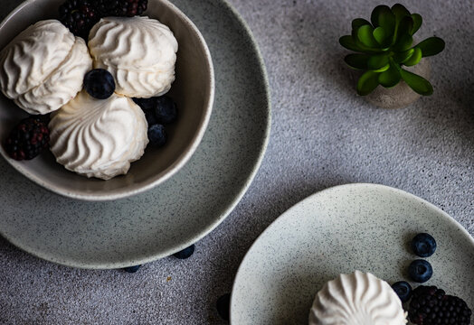 Overhead view of zefir dessert with blueberries and blackberries on a table