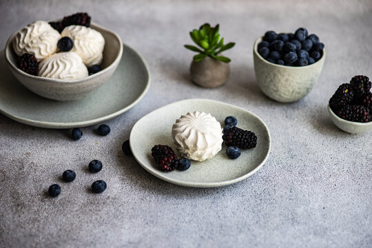 Zefir dessert with blueberries and blackberries on a table