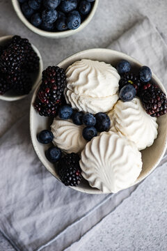 Overhead view of zefir dessert with blueberries and blackberries on a table