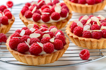 Mini tartlets with custard and raspberries.