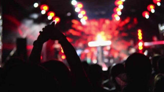 Happy people dance in party concert and listen to music from the stage