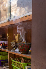 Incense  smoke rises from a cup on a gift shop shelf in Christian quarters in the old city of Jerusalem, Israel