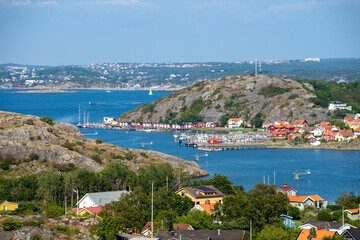View over Swedish west coast archipelago and main land. Small fisherman harbor