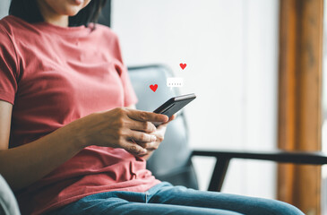 Women use smartphone typing on mobile smartphone with heart icon, Live Chat Chatting.