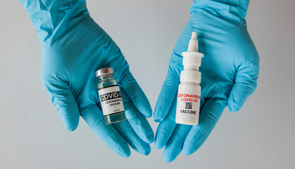 intranasal and liquid covid vaccine in the nurse's hand - obrazy, fototapety, plakaty