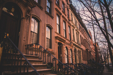 Row of old brownstone buildings along an empty sidewalk block in the Greenwich Village neighborhood...