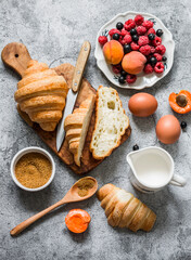 Preparation croissants brown sugar cinnamon baked French toast with berries on a gray background, top view