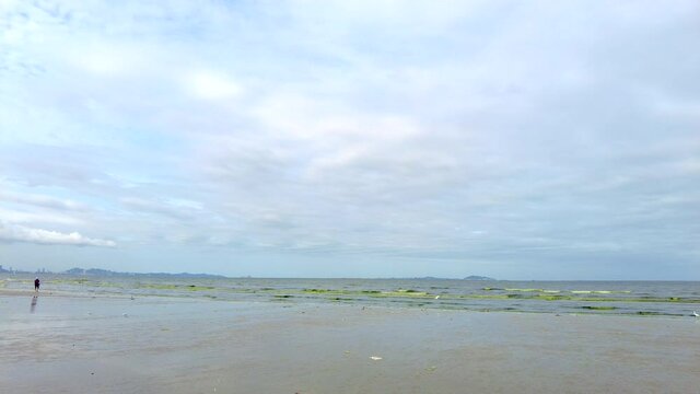 4k footage panning shot from left to right of tropical Thailland beach sea and sand on the couldy sky day for use as a background composition video.