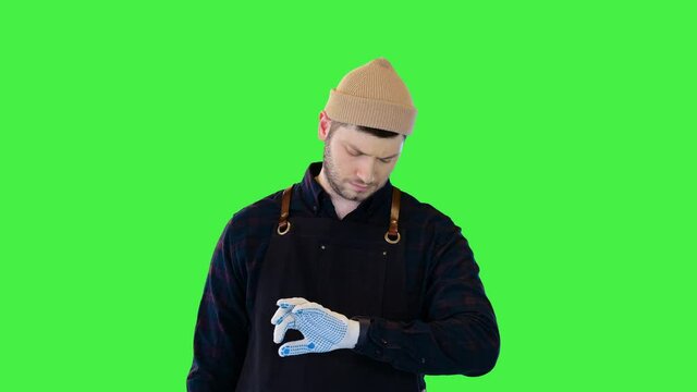 Plumber stand checking time Repairman construction worker handyman plumber waiting for client late on a Green Screen, Chroma Key.
