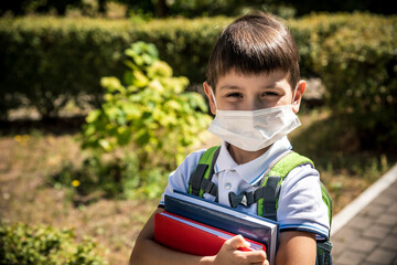 Child wearing face mask going at reopen school after covid-19 quarantine and lockdown. It is new...