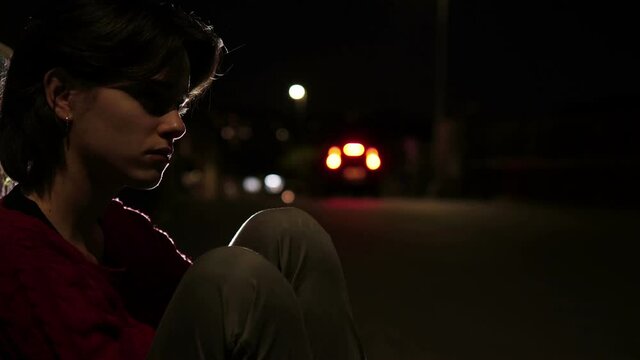 loniless, depression -girl sitting on the sidewalk thinks about her ex boyfriend