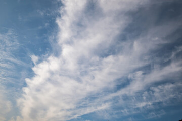 Naklejka na ściany i meble Blue sky background with big white tiny stratus cirrus striped clouds