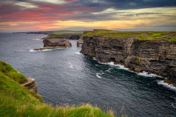 Rocky cliffs in Kilkee at sunset, County Clare. Ireland.