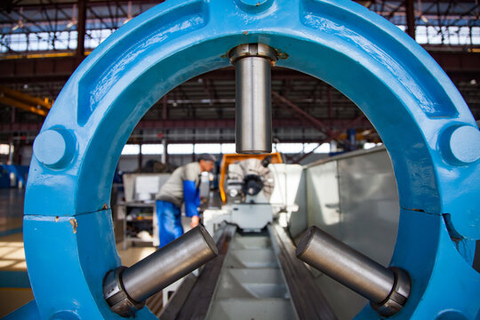 Holder of turning lathe on foreground close-up. Turner (operator) on background, blurred. Atyrau,KazakhstanKazturboremont plant. 