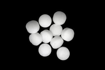 White naphthalene balls isolated on black background