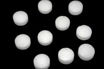 White naphthalene balls isolated on black background