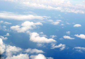 Sky view with white clouds from a passenger plane porthole