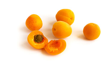 A bunch of ripe apricots on a white isolated back