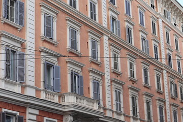 Fototapeta na wymiar Rome Piazza Risorgimento Square Pink Building with Windows, Grey Shutters and Balcony 