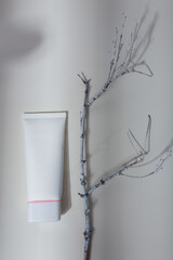 Mock up tube, no brand label and branch on white background with light shadow play. Face skin care cosmetics template