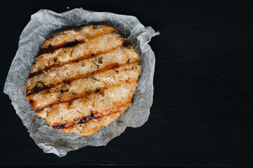 Cooked ground chicken meat steak cutlets on black table for background.