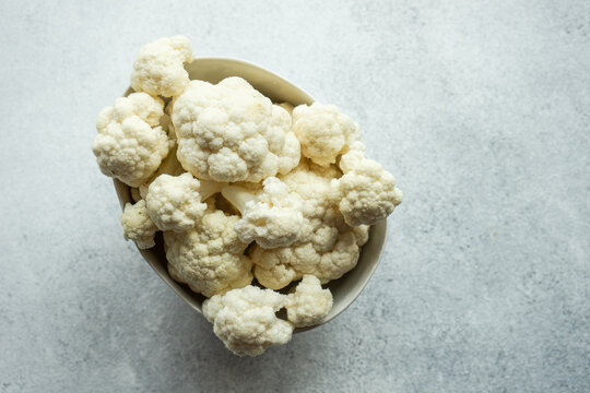 Overhead view of a bowl of cauliflower florets