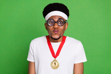 Portrait of attractive trendy funky guy nerd sportsman wearing medal grimacing isolated over bright...