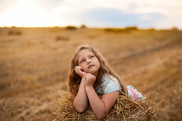 Portrait of a girl in holding bouquet of daises field flowers. Beautiful girl in the agricultural field