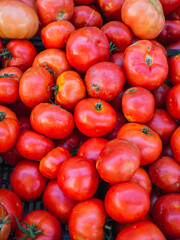 Close detail of a pile of raw tomatoes at the neighborhood market. Top view. Healthy concept
