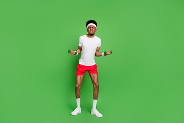 Fototapeta na wymiar Full length body size view of trendy attractive weak guy sportsman doing exercise isolated over bright green color background