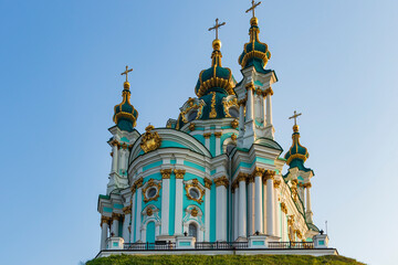 St. Andrew's Church in Kiev, located on a hill, bottom view with a white and blue facade and green domes with gilding, was built in the Baroque style